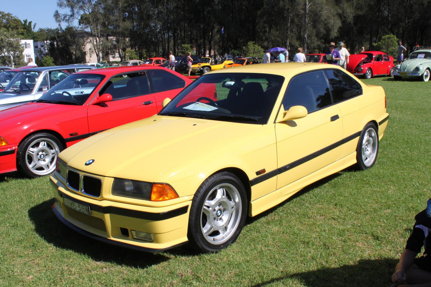 Classic yellow coupe with iconic front grille and sporty alloy wheels