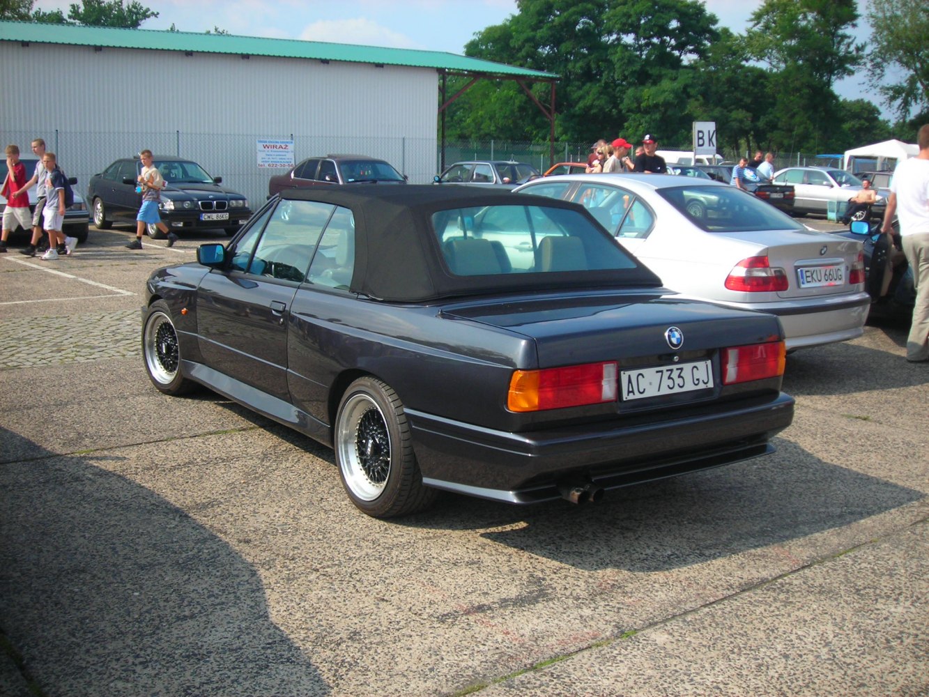 Rear view of classic convertible with soft top and distinct taillights.