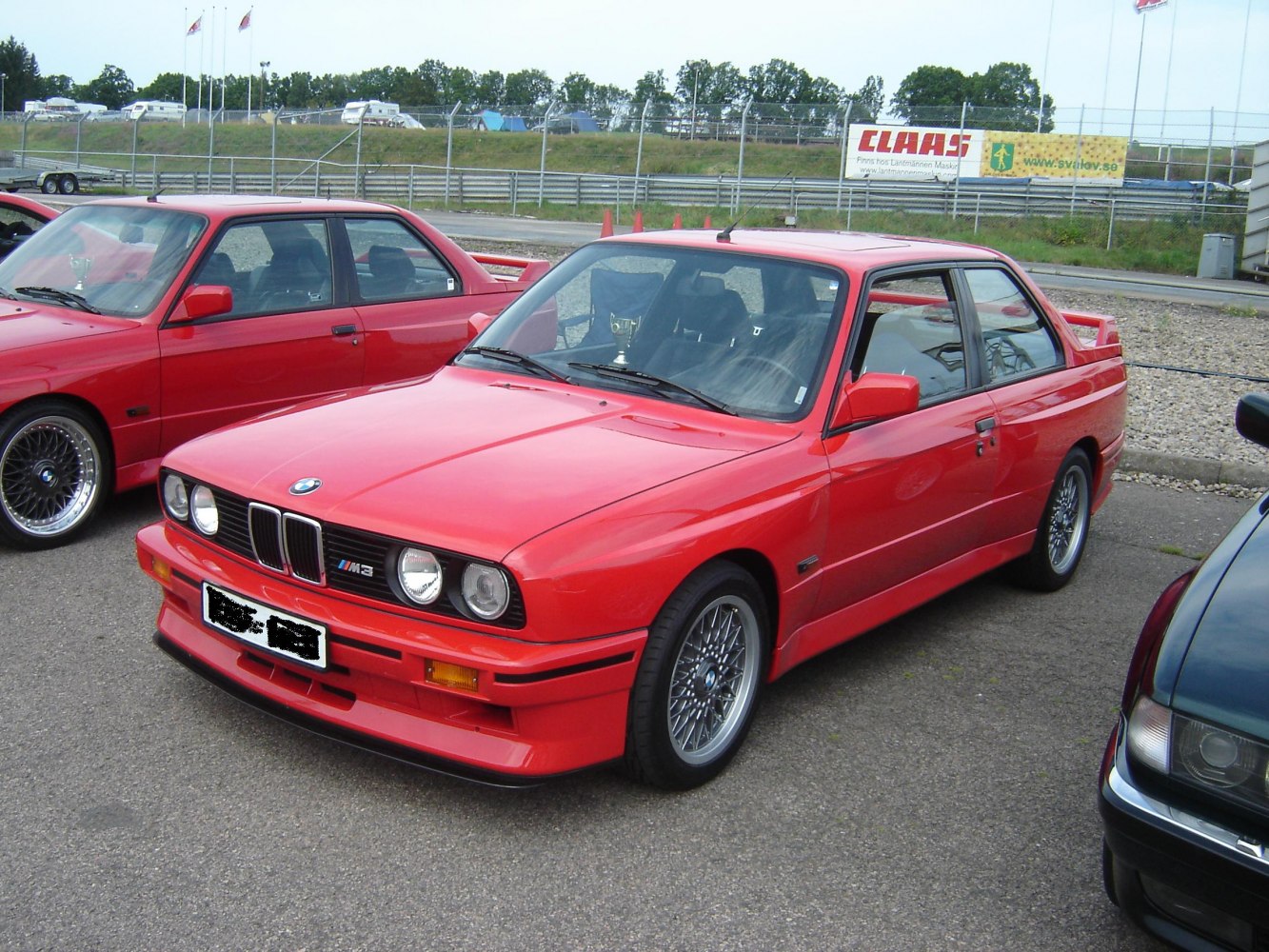 Red classic coupe with quad headlights and sporty alloy wheels