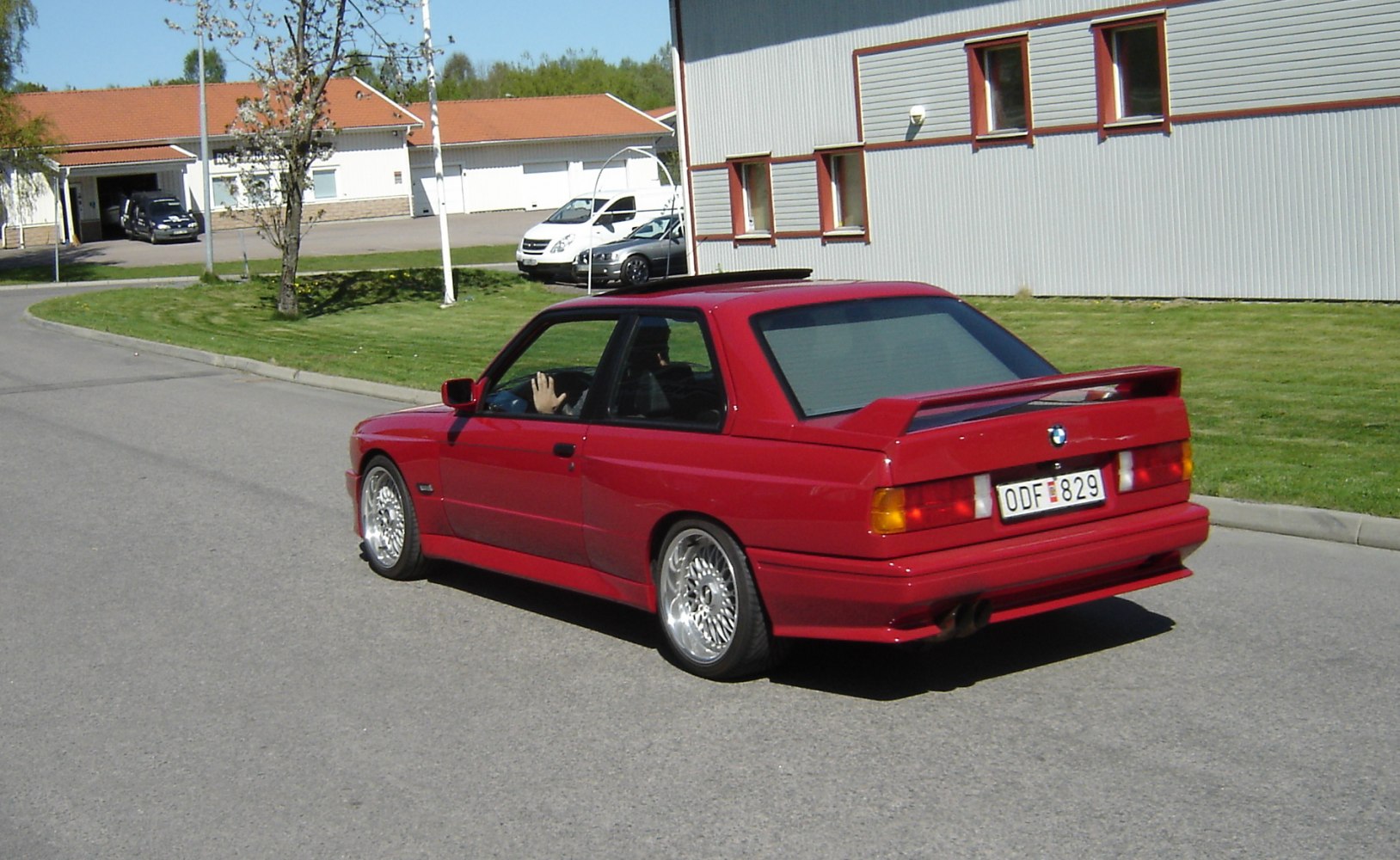Rear view of red coupe with spoiler and alloy wheels