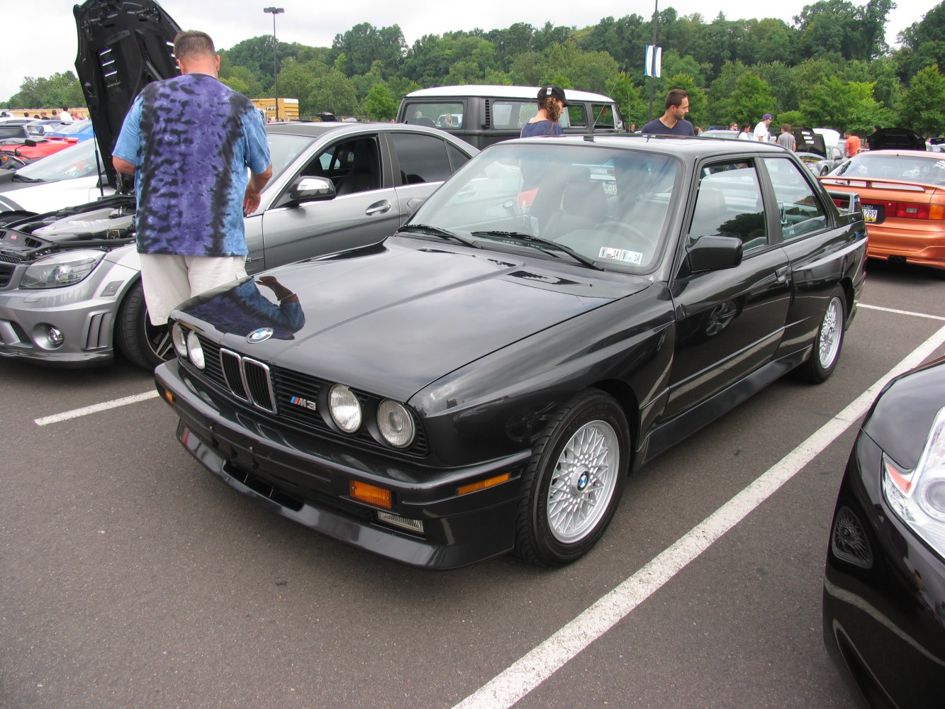 Black vintage coupe with distinctive quad headlights and multi-spoke alloy wheels