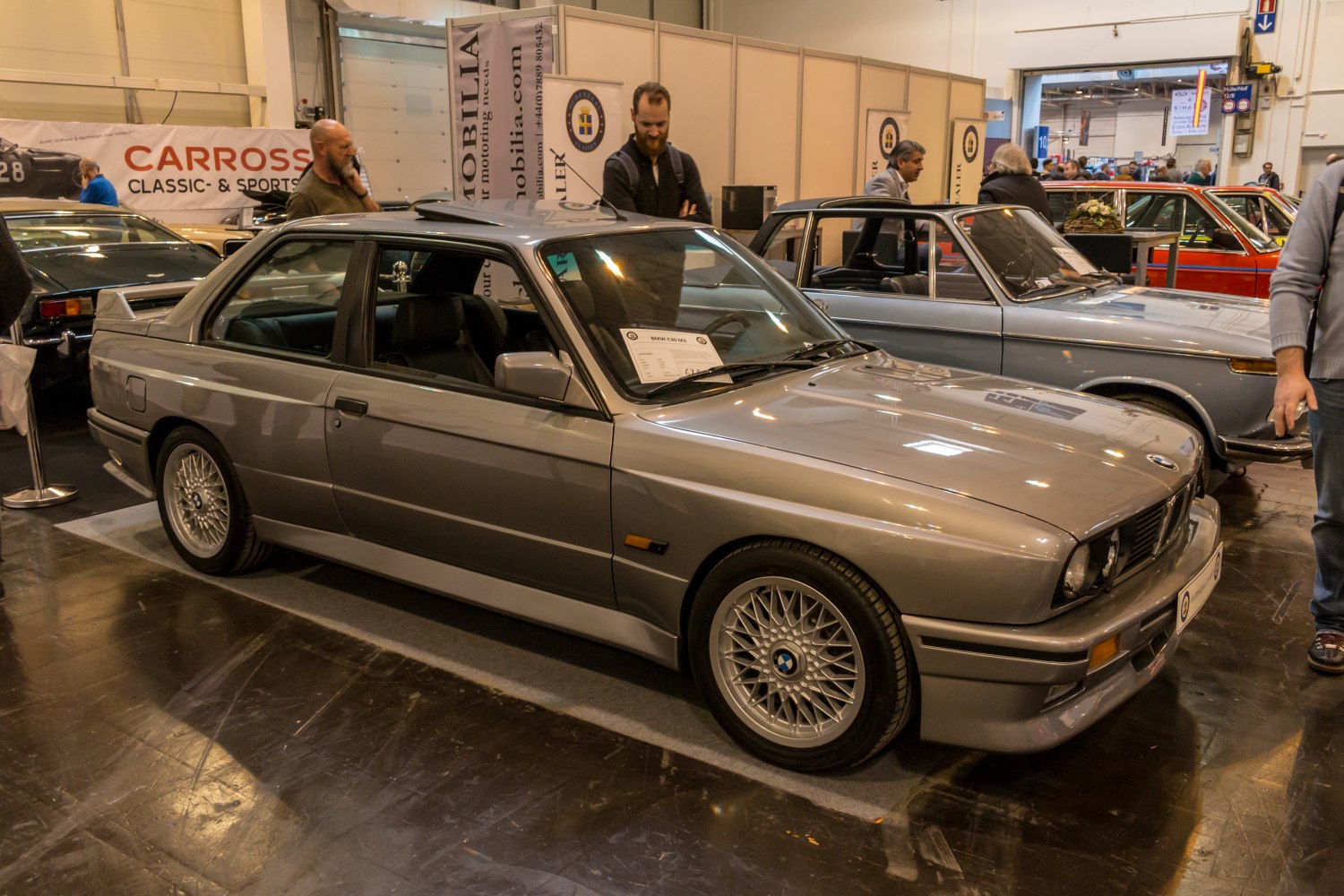 Side view of vintage coupe with mesh wheels and rear spoiler