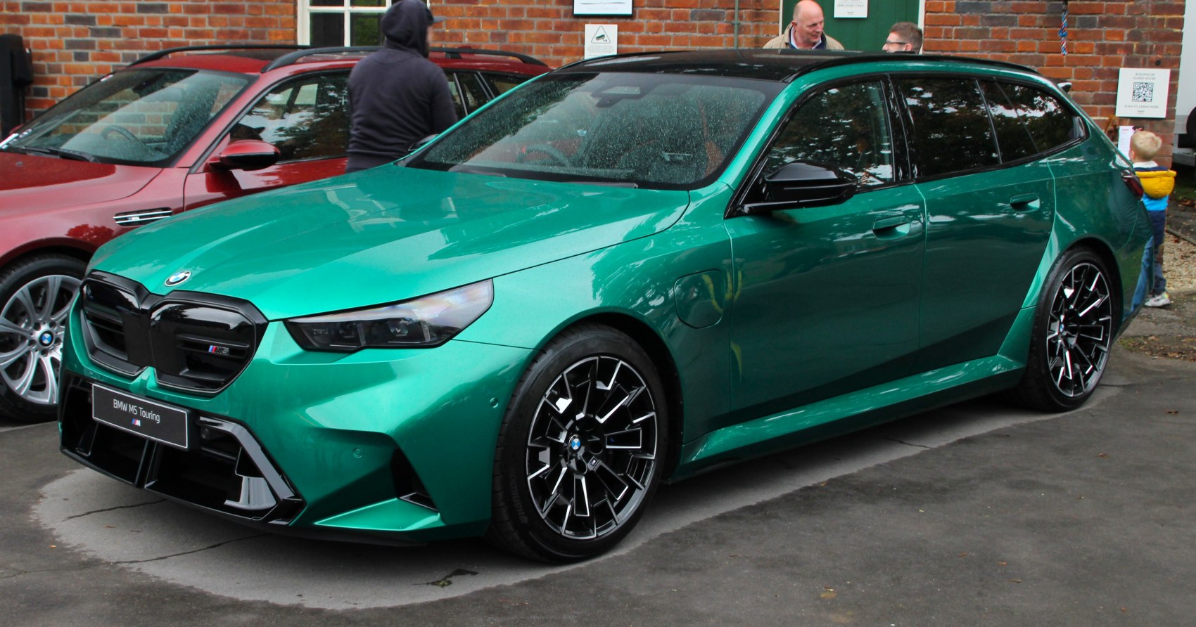 Sporty metallic green high-performance touring with aggressive grille and black wheels