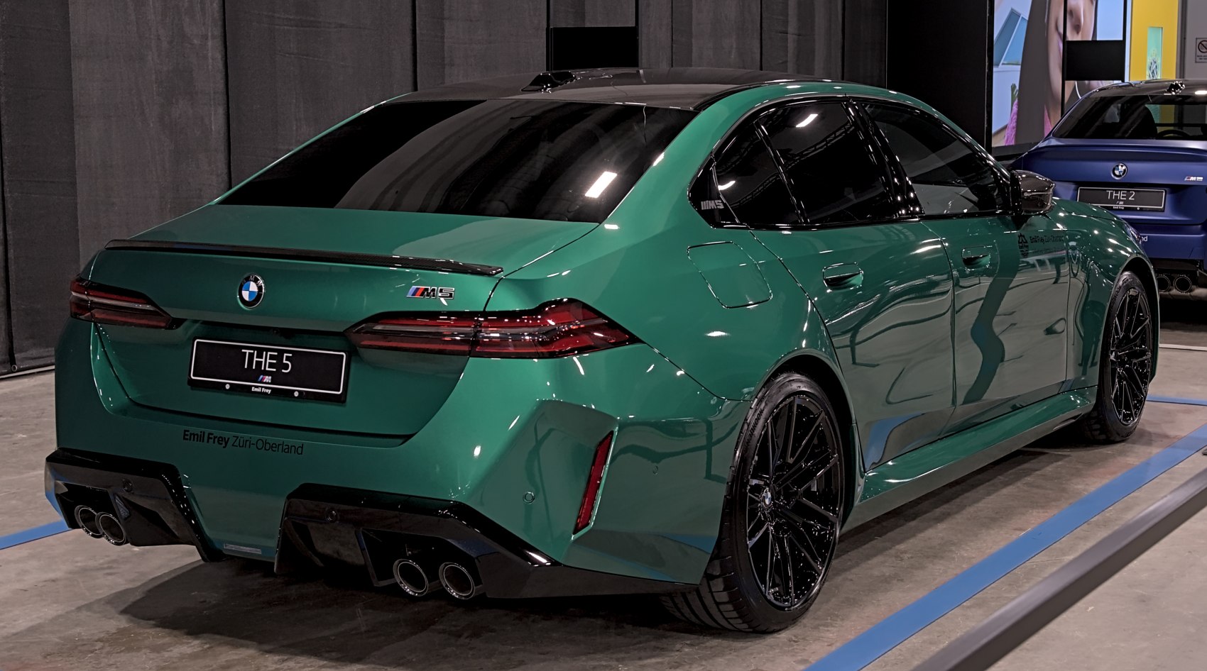 Rear view with quad exhaust, aerodynamic diffuser, and sleek taillights