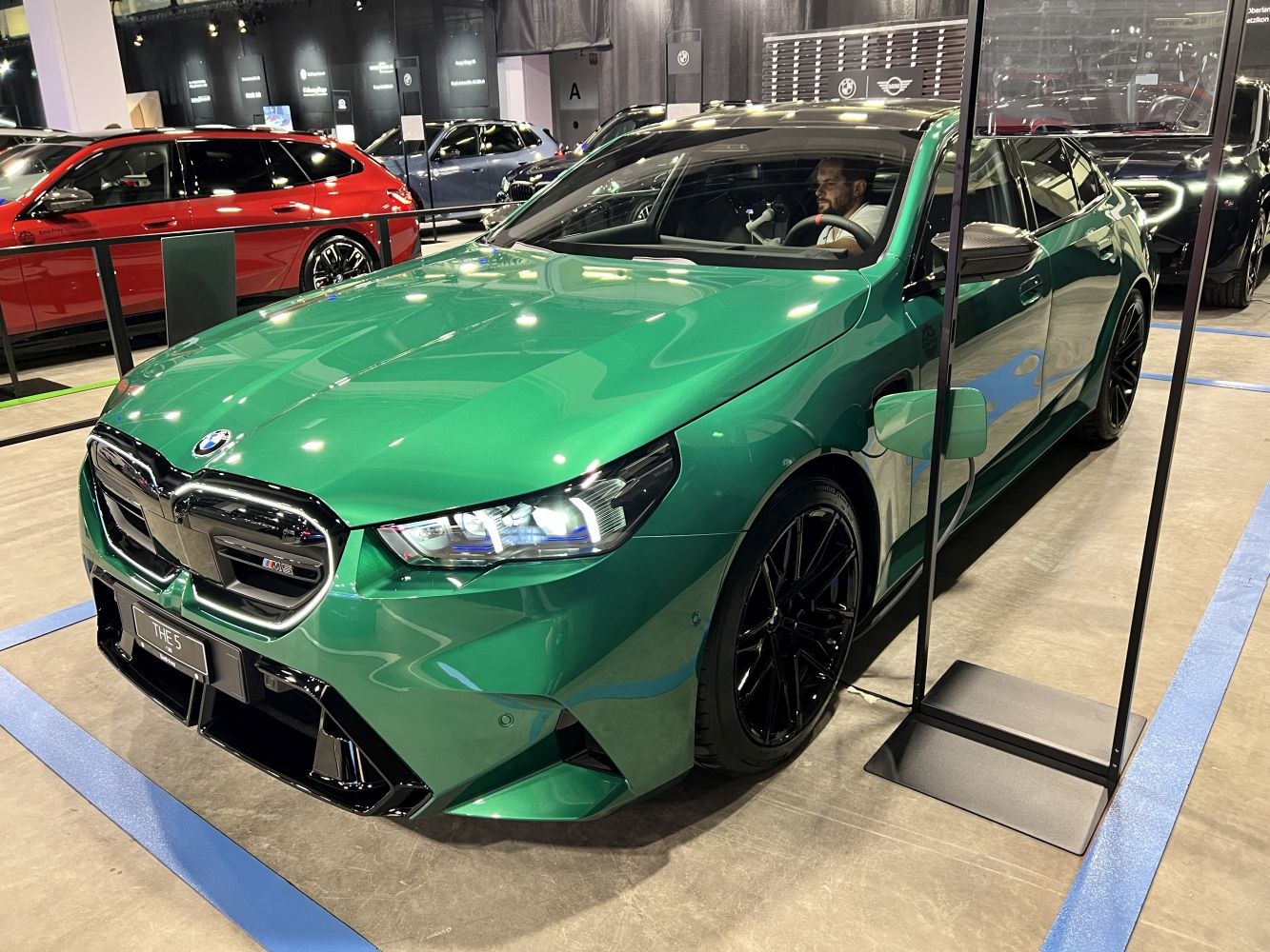 Green high-performance sedan front with LED headlights & black wheels