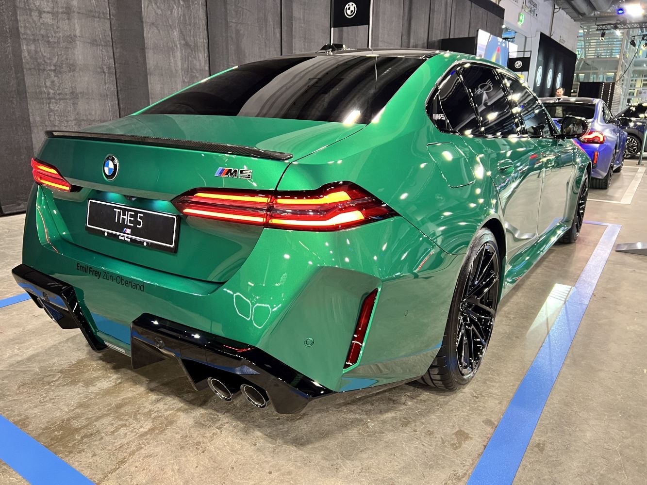 Green sedan rear with quad exhaust and LED taillights