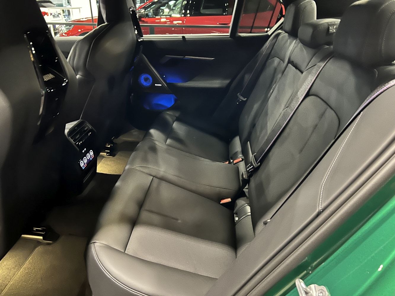 Black leather rear seats with ambient blue lighting and air vents