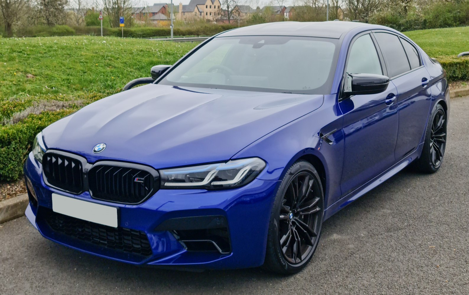 Front view of sleek sporty sedan with LED headlights and black alloy wheels