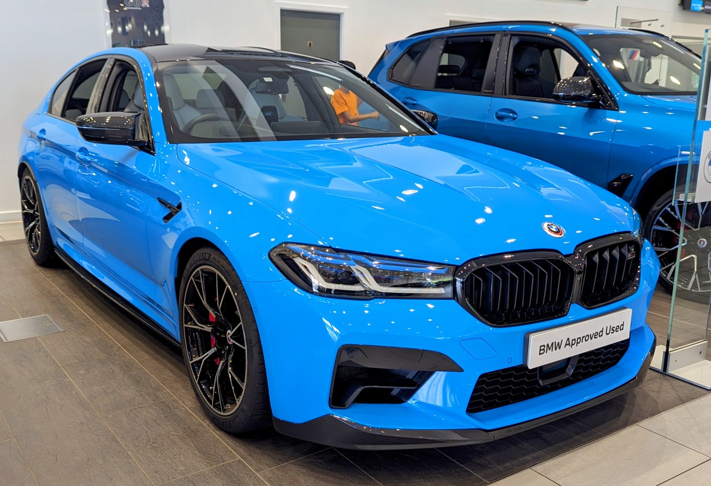 Blue sporty sedan with aggressive black grille and black alloy wheels
