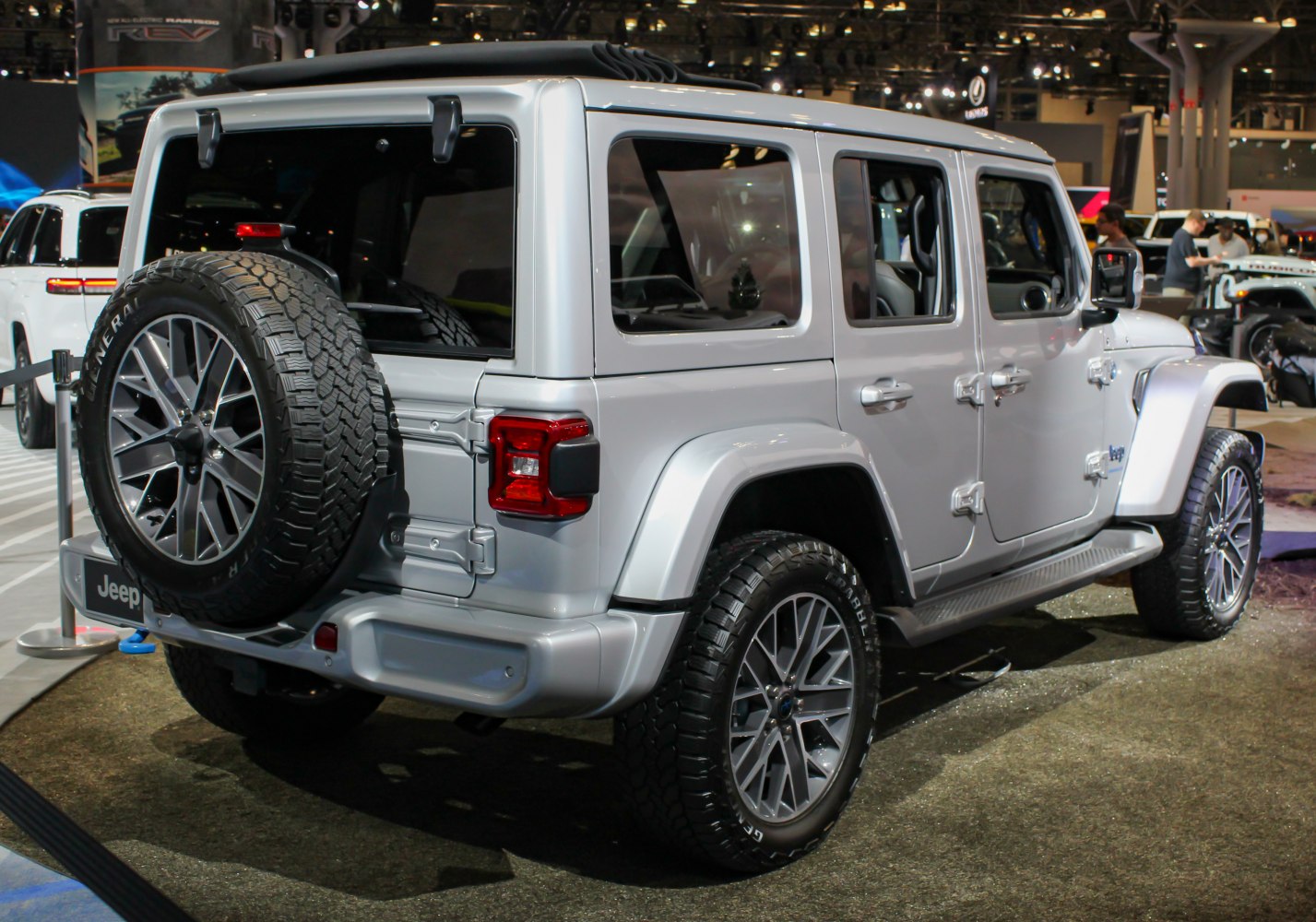 Silver SUV rear side with spare tire and alloy wheels