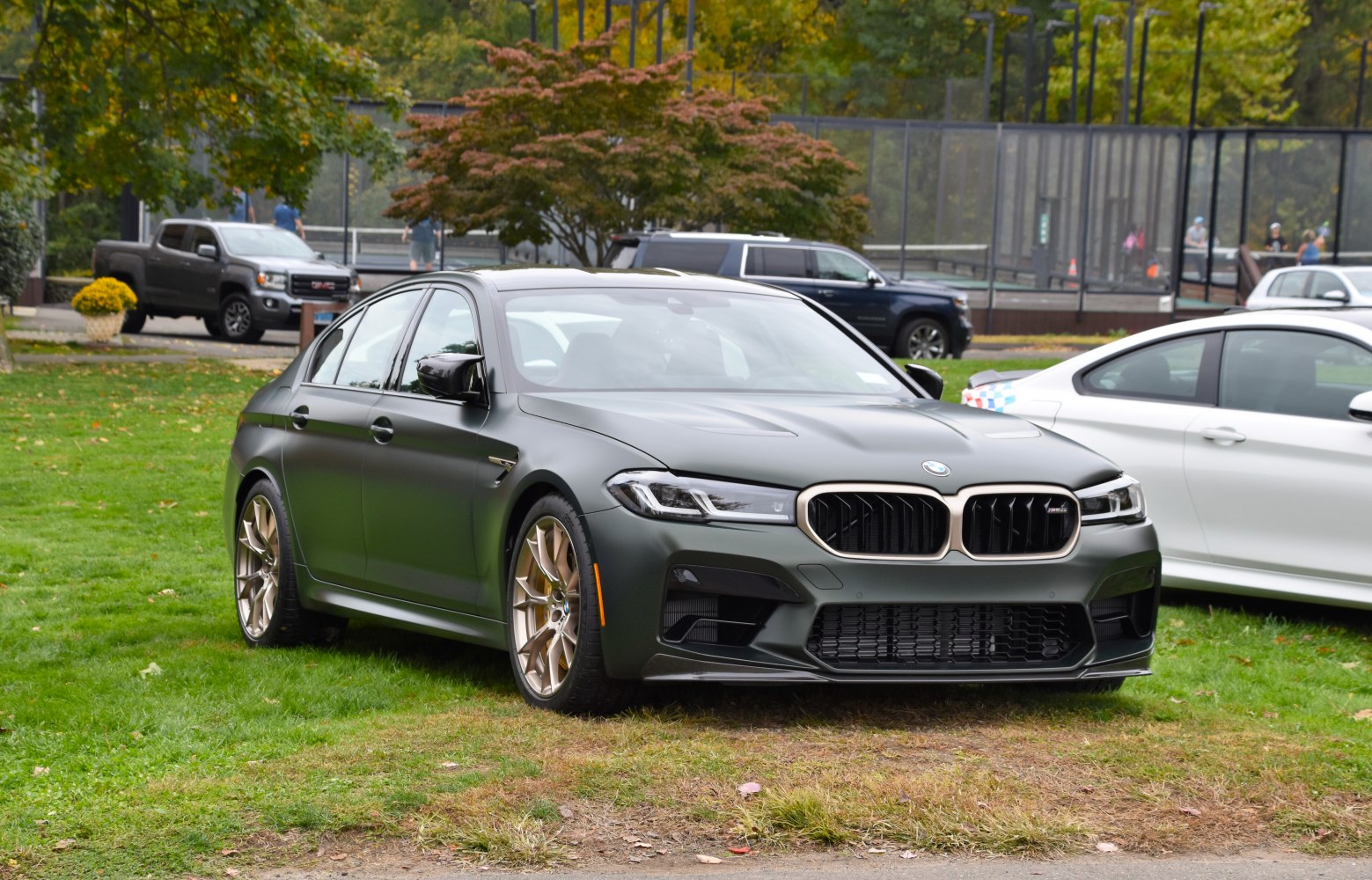 Matte finish sedan with gold alloy wheels front perspective