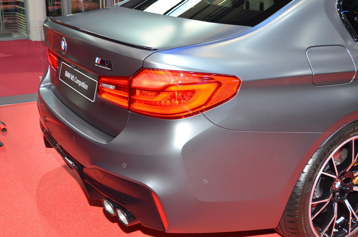 Rear tail light and quad exhaust of a performance sedan