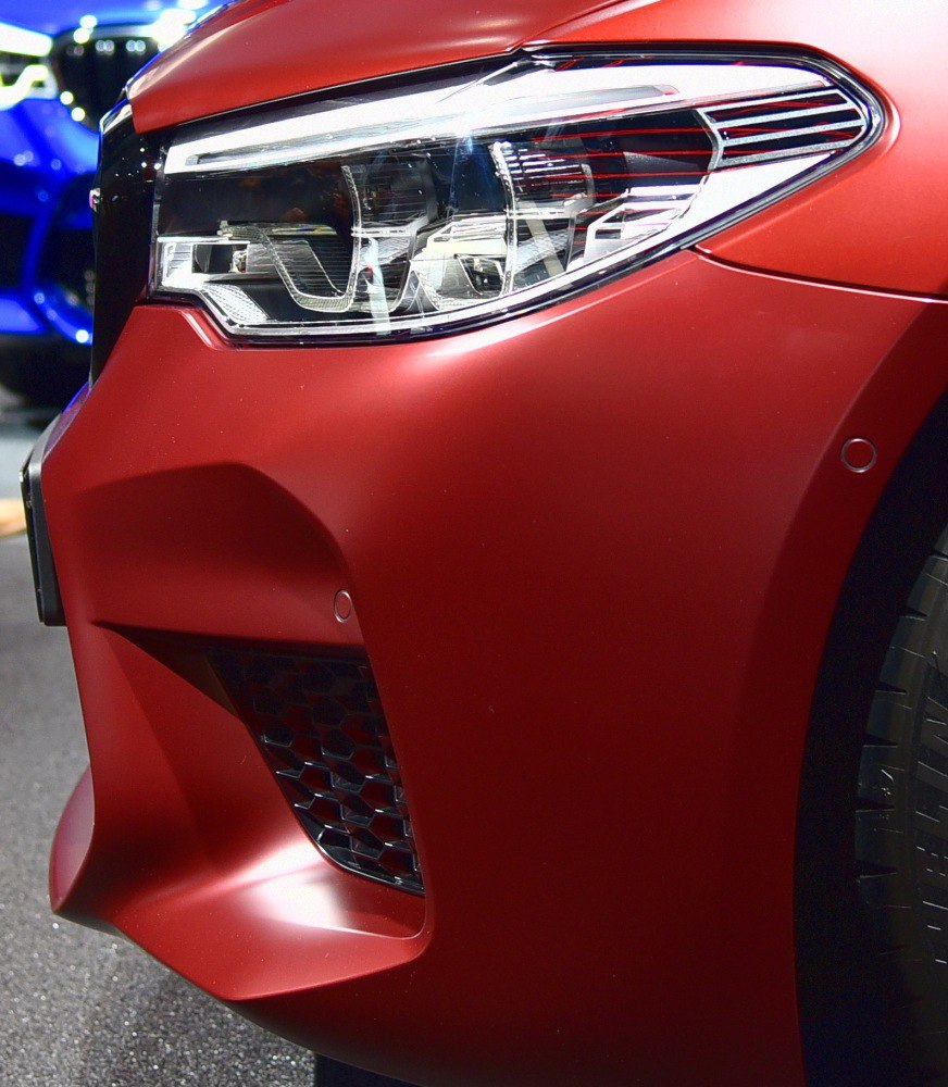 Close-up of front headlight and air intake with sharp design lines