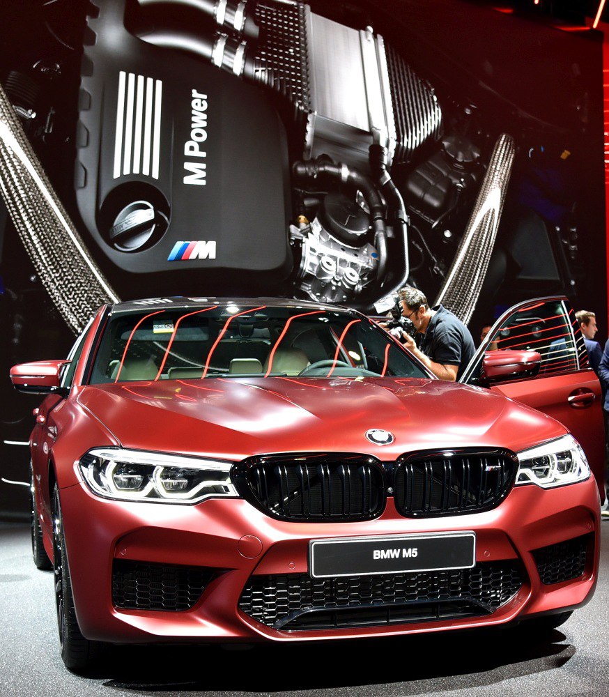Front view of sporty sedan with M Power engine background