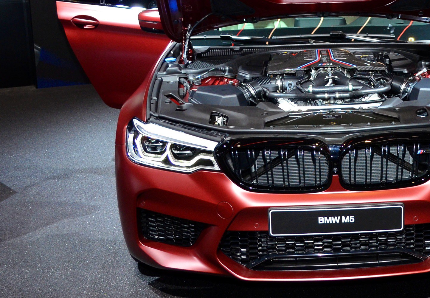 Close-up of high-performance engine and front grille with LED headlights
