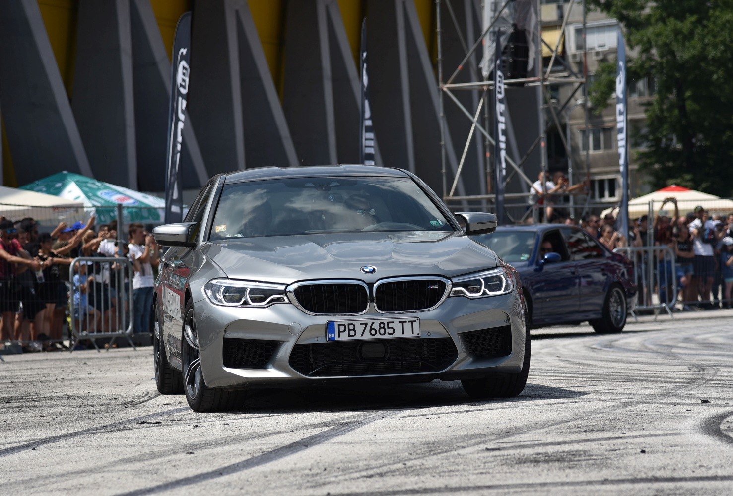 Silver high-performance sedan with aggressive front grille and LED headlights.