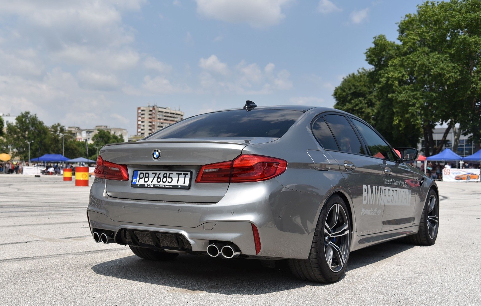 Rear view with quad exhaust, diffuser, alloy wheels on sport sedan