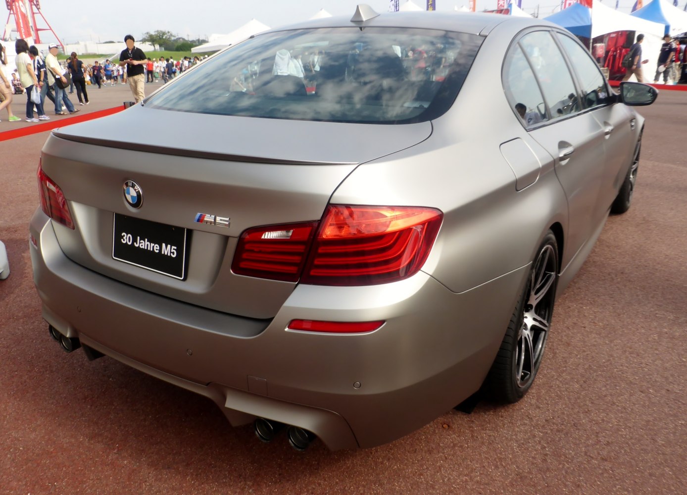 Rear view with quad exhausts, taillights, trunk spoiler