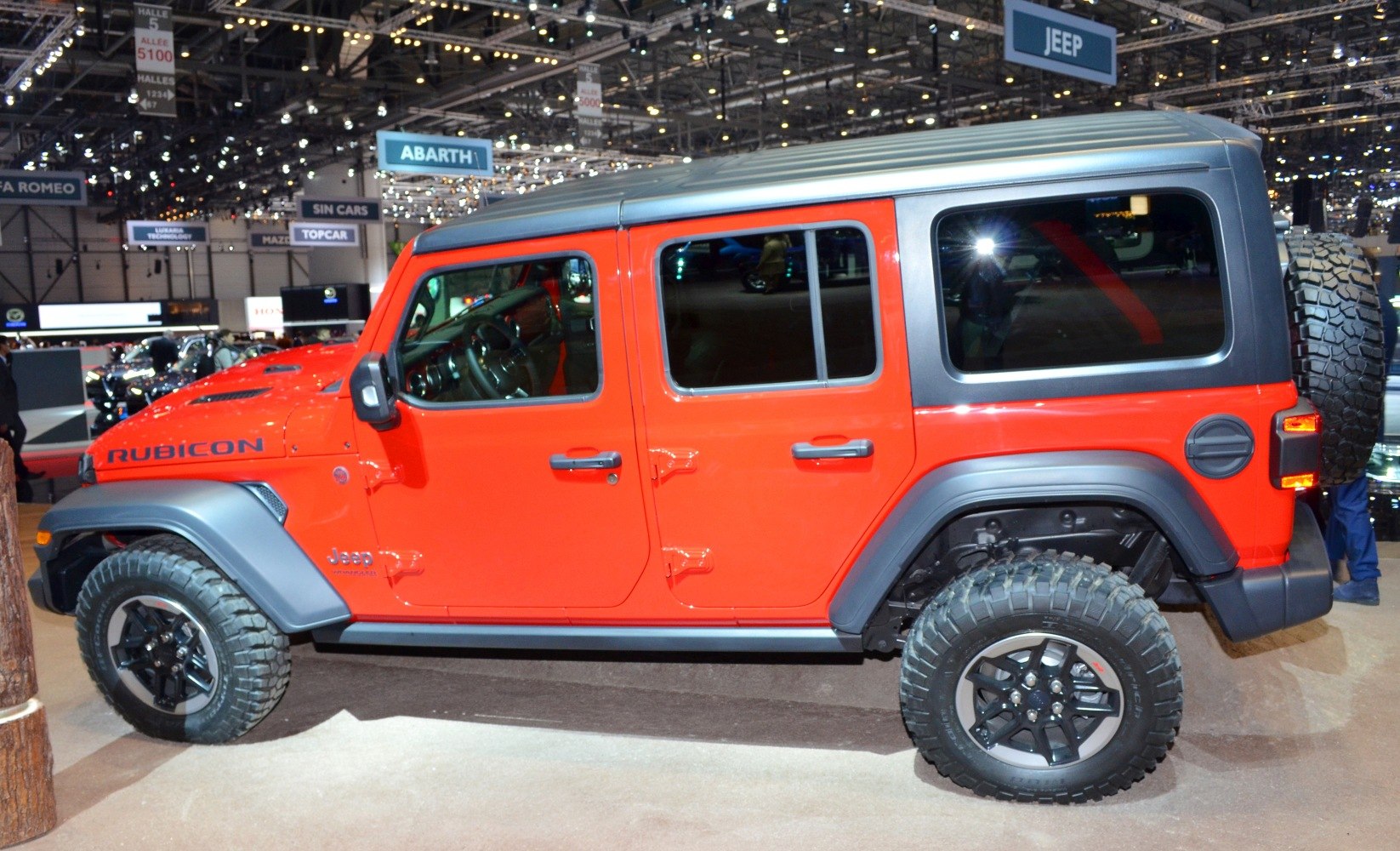 Four-door off-road SUV side view with rugged tires and black roof
