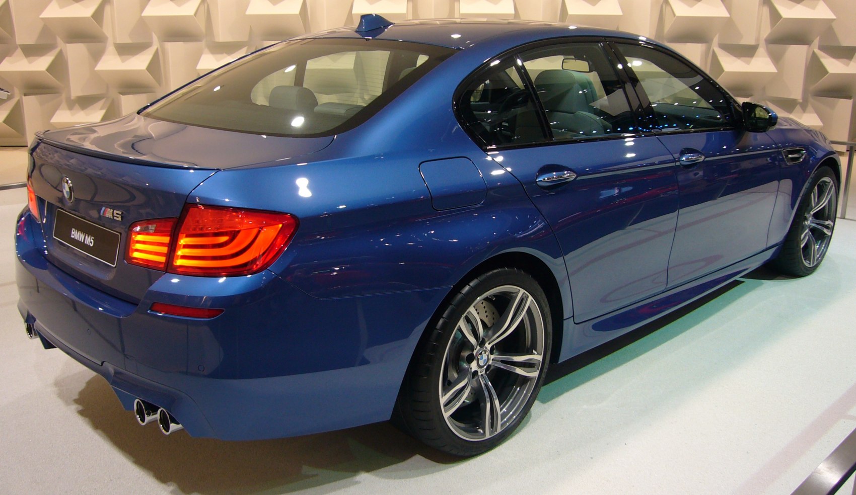 Rear-side view with LED taillights, quad exhaust, and sporty alloy wheels