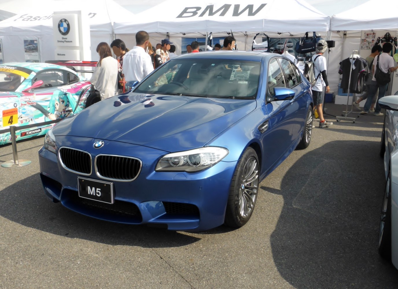 Blue BMW M5 F10M front and side view with signature kidney grille and sporty design