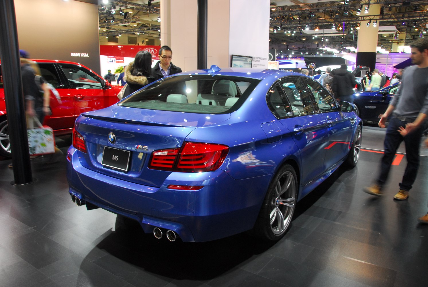 Rear view of a sporty sedan with quad exhausts and rear spoiler