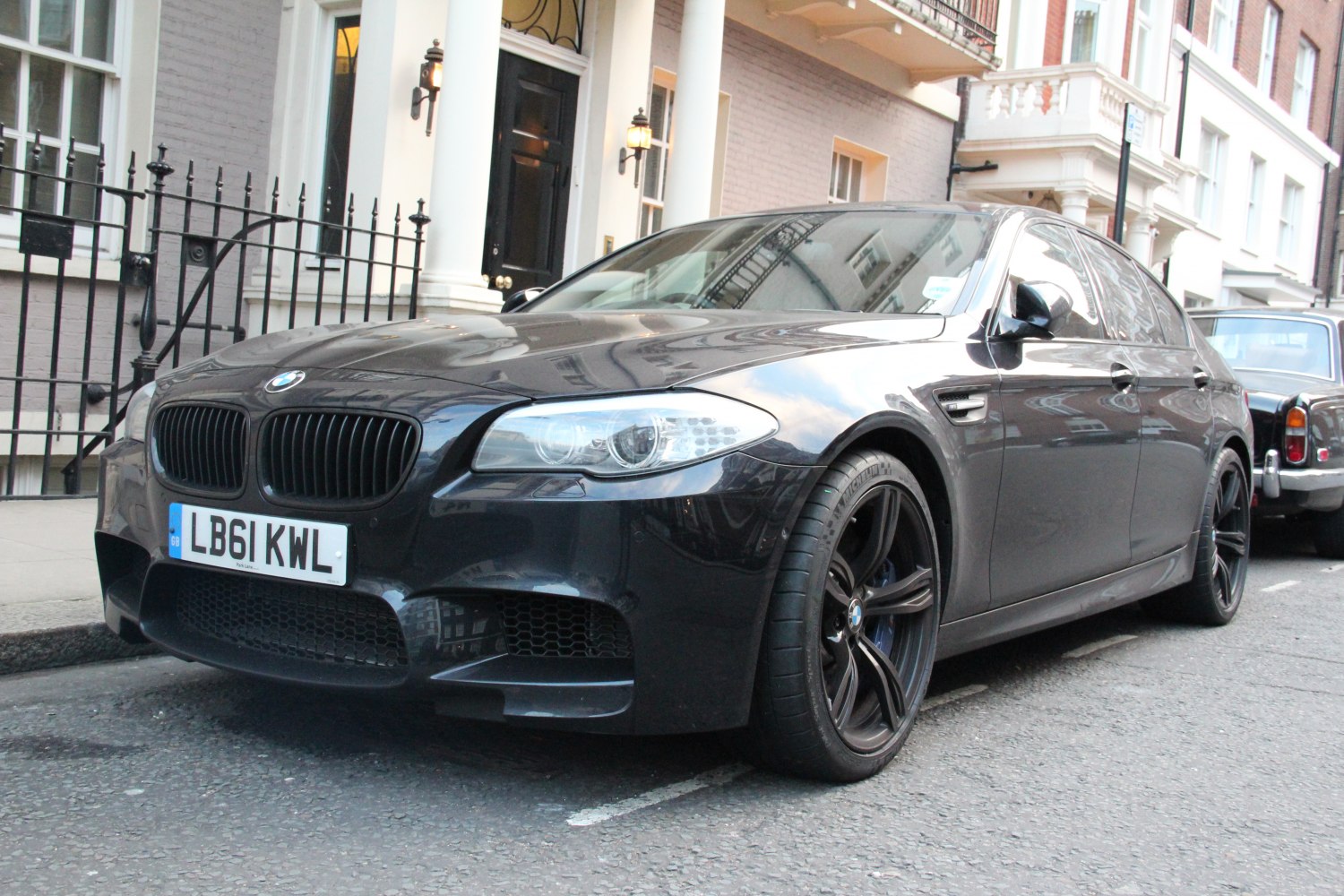 Front view of high-performance car with black alloy wheels and distinctive headlights