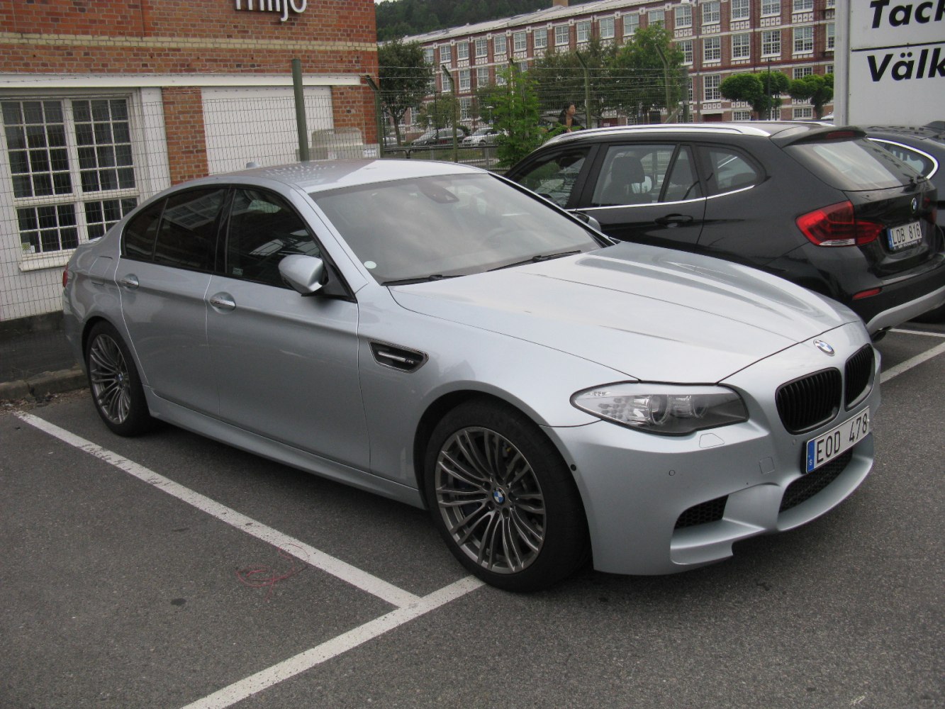 Silver sedan with sporty front grille and multi-spoke alloy wheels