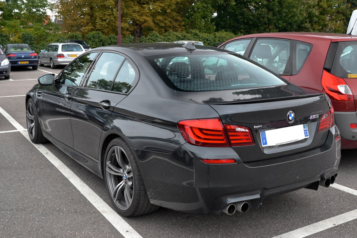 Quad exhaust outlets with distinctive tail lights on a sedan rear