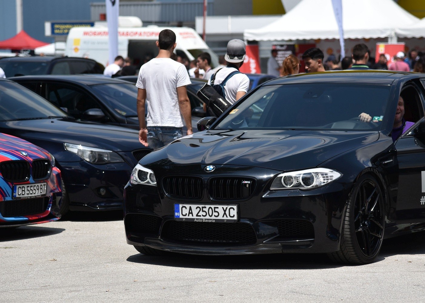 Black sedan with distinctive BMW kidney grille and angel eye headlights