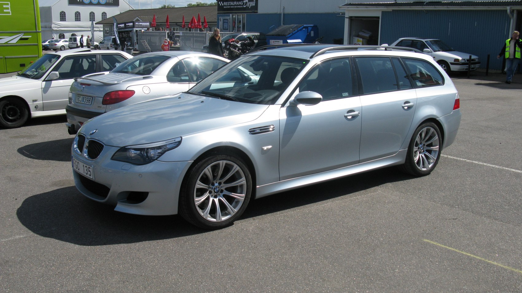 Silver BMW station wagon with sporty alloy wheels and aerodynamic profile