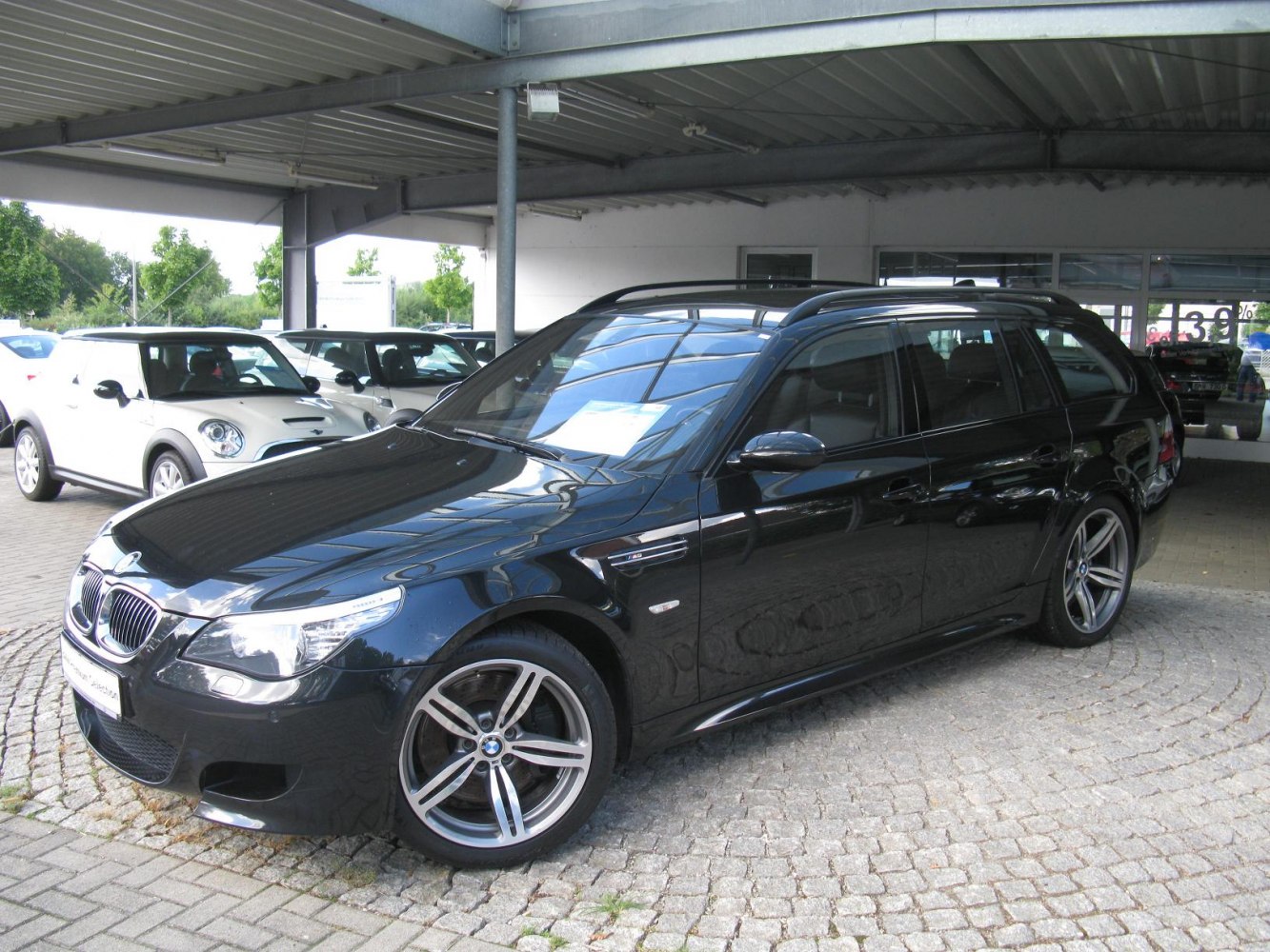 Black sporty estate car with alloy wheels front side view