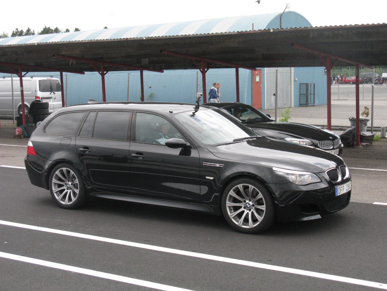 Black sporty BMW M5 Touring wagon with alloy wheels