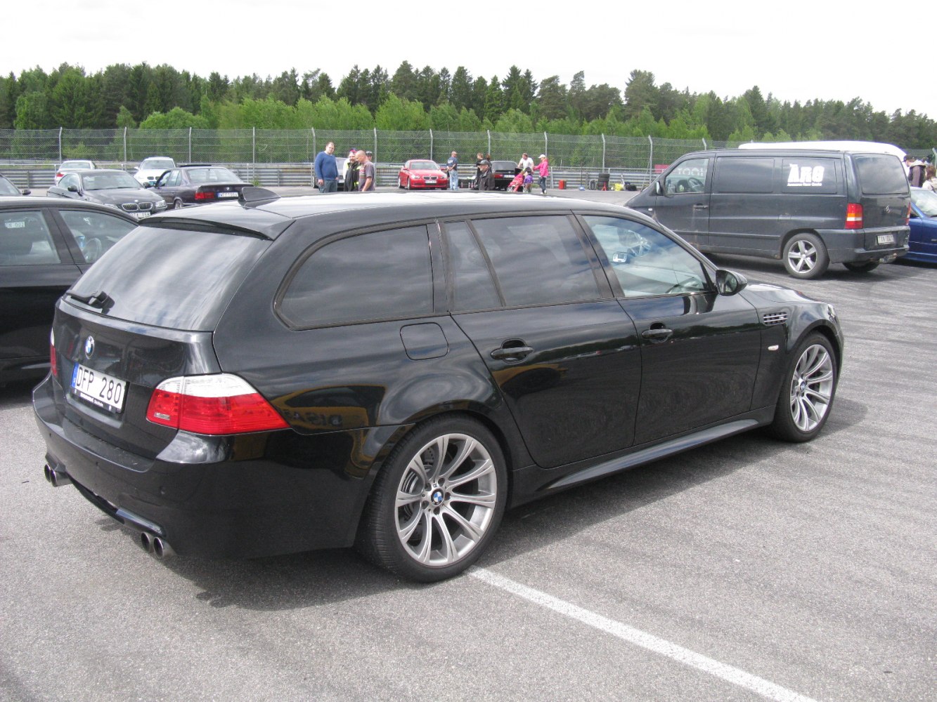 Black sporty station wagon with alloy wheels, rear side view