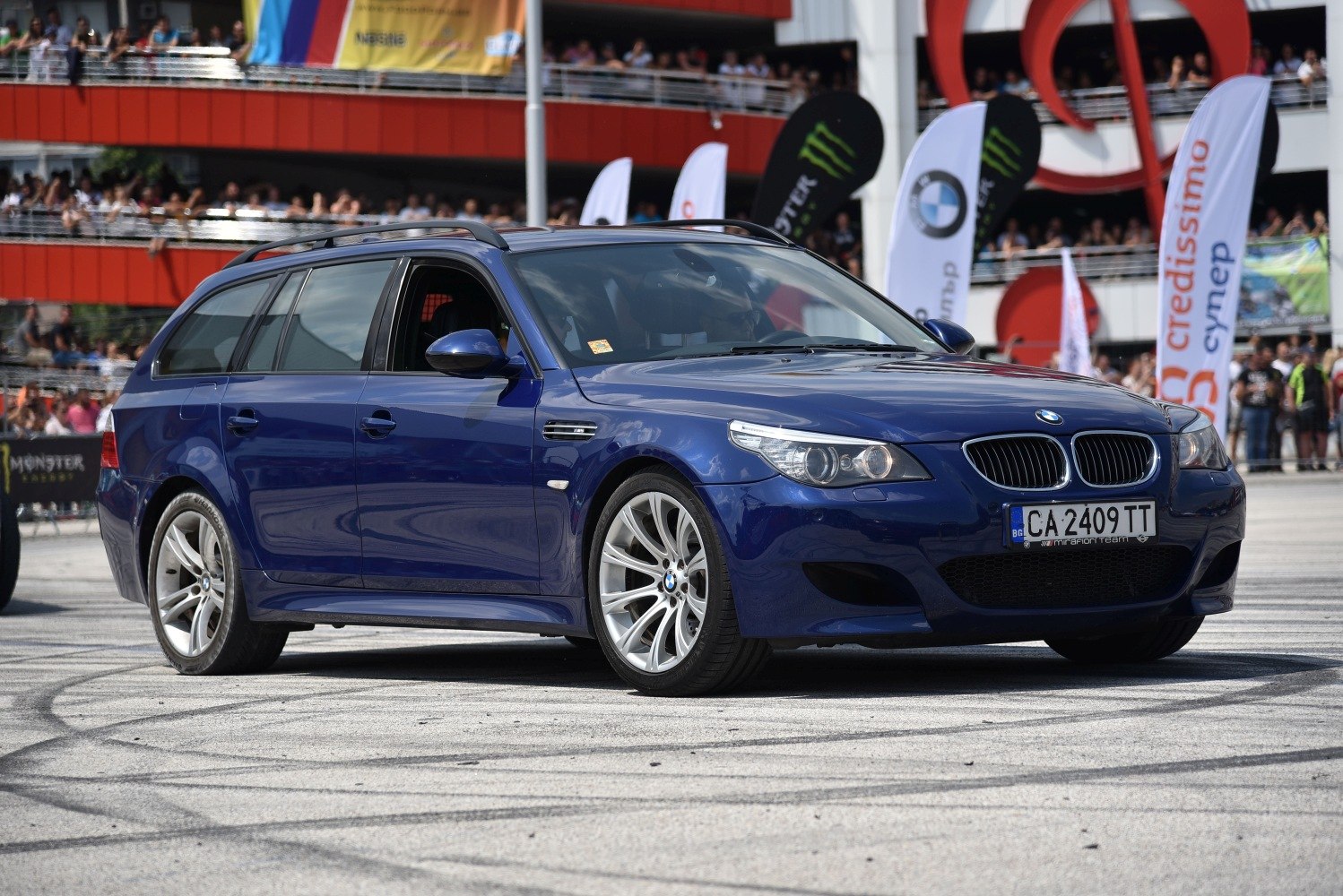 Blue sporty wagon with performance wheels and aggressive front fascia