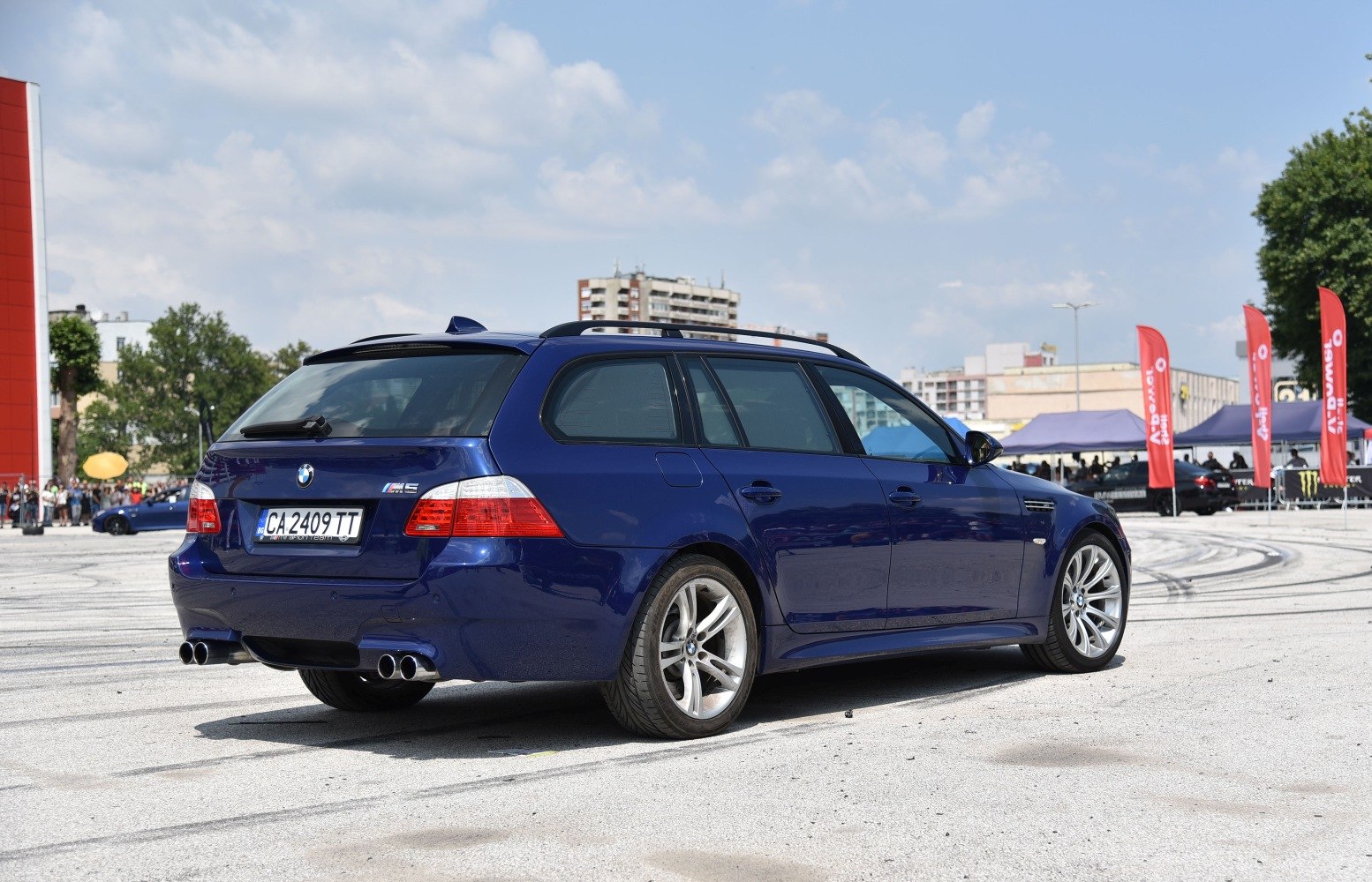 Sporty blue station wagon with quad exhaust and alloy wheels
