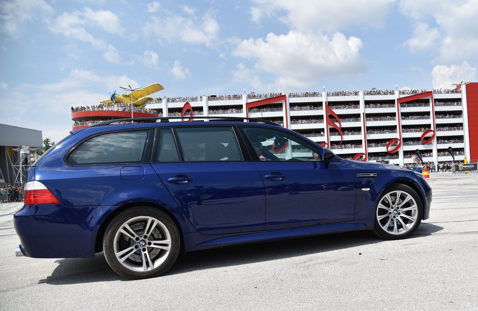 Blue high-performance station wagon with alloy wheels and roof rails