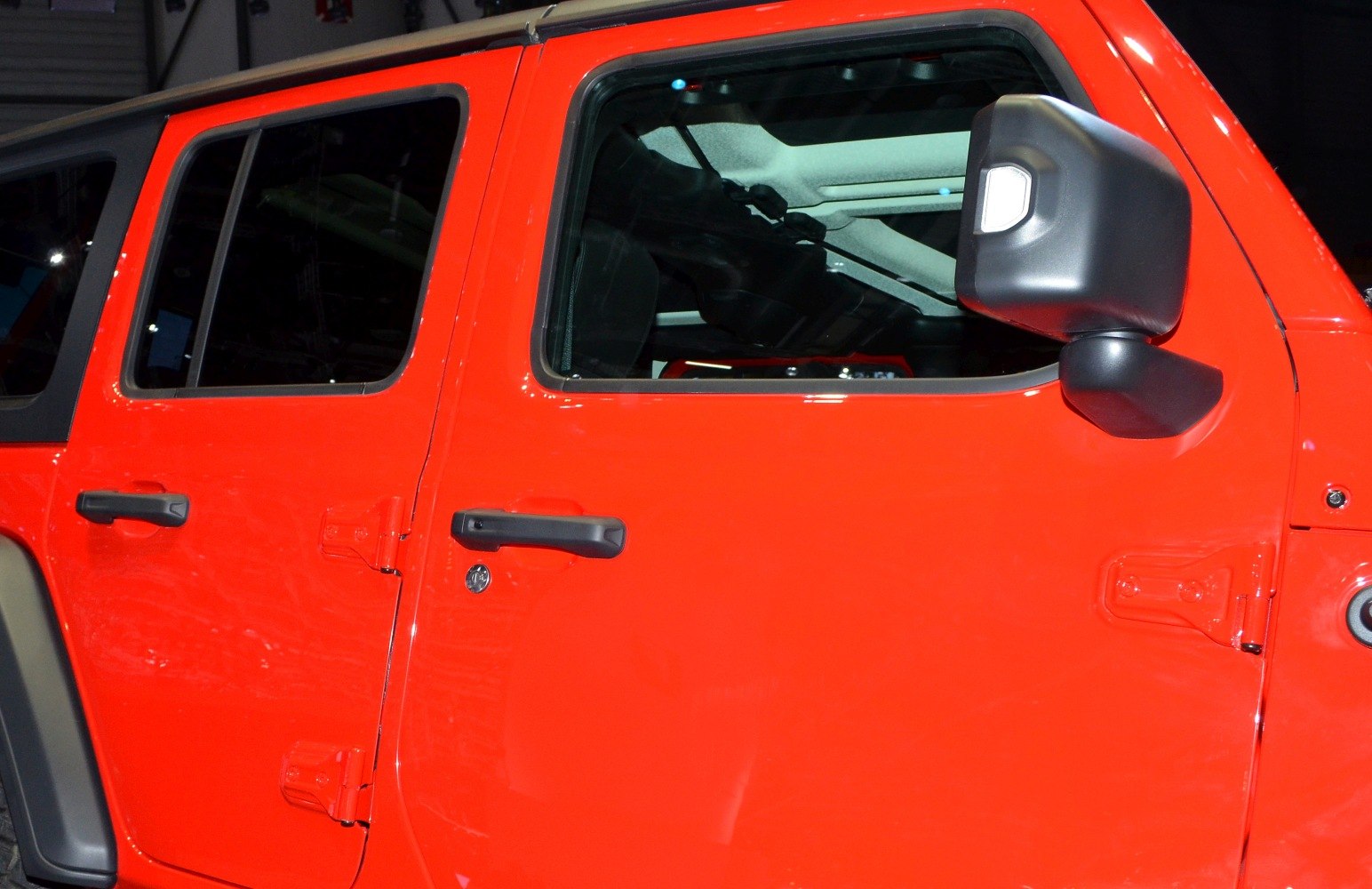 Red door and side mirror with black handles and hinges