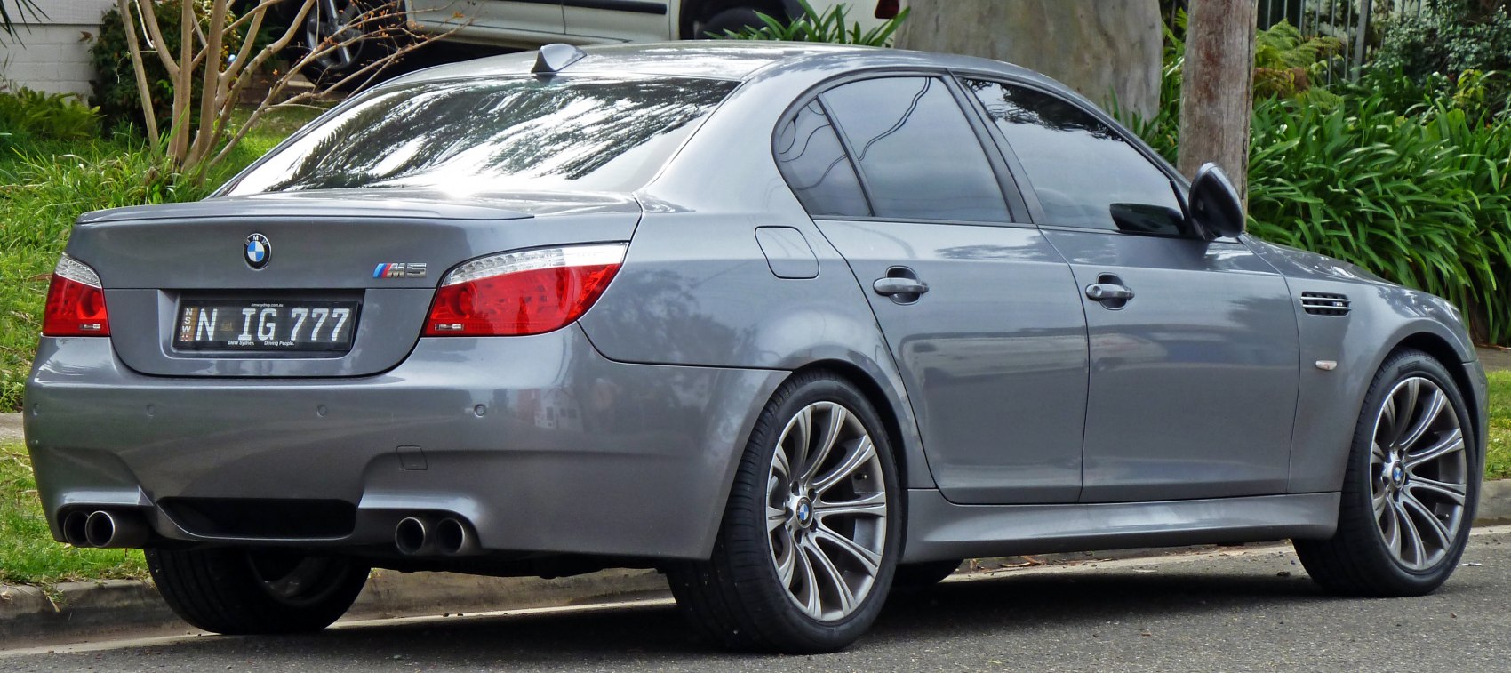 Rear side view with quad exhaust and alloy wheels