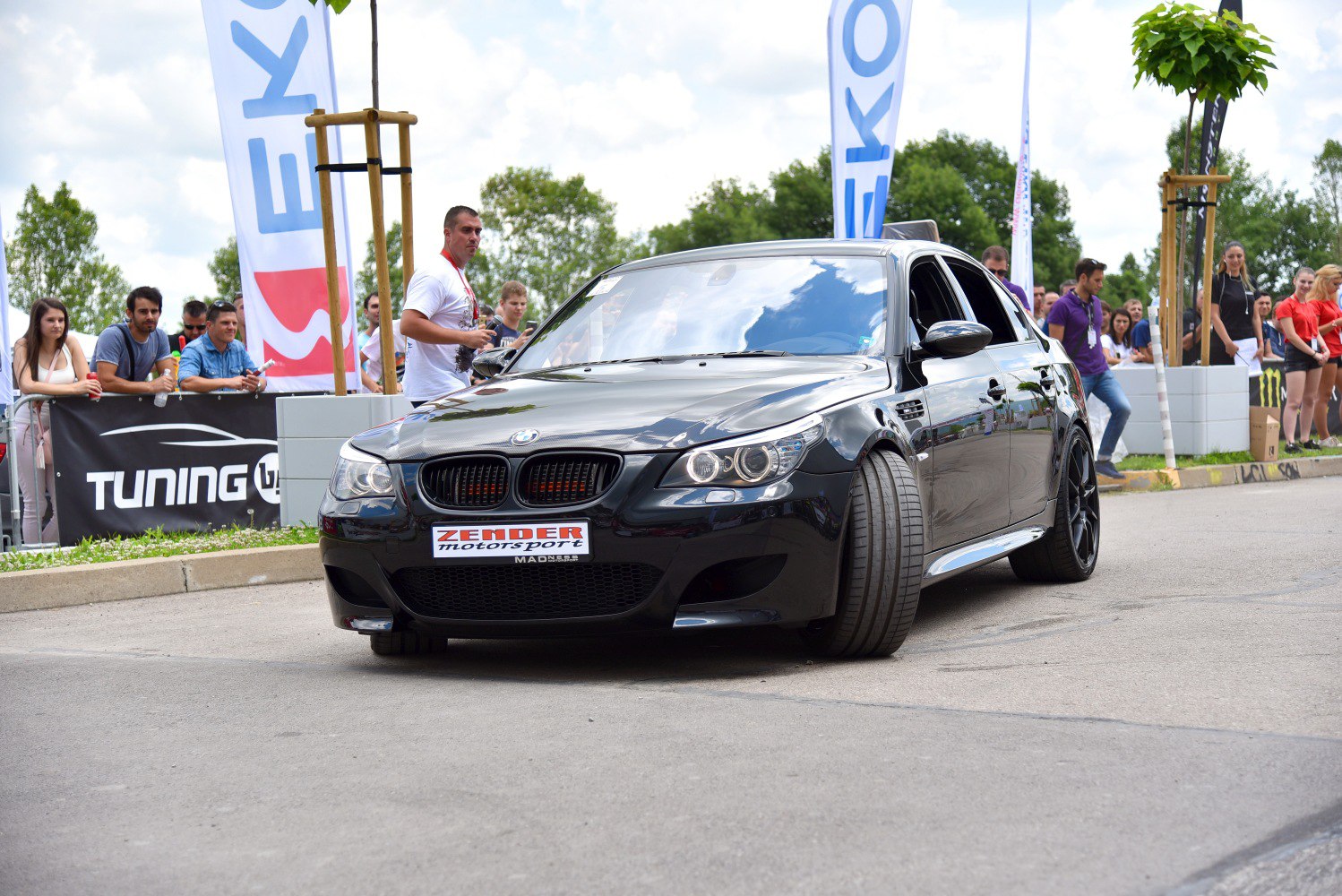 Black sedan with sporty front grille and aggressive stance
