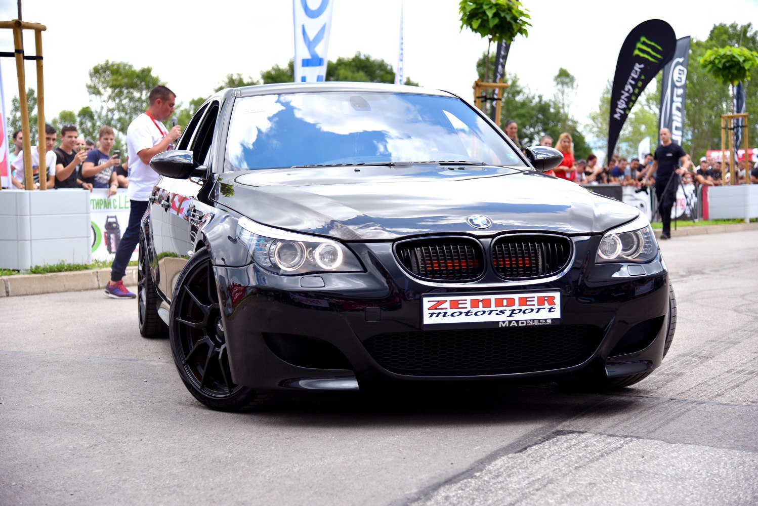 Front view with dual round headlights and black sporty wheels.