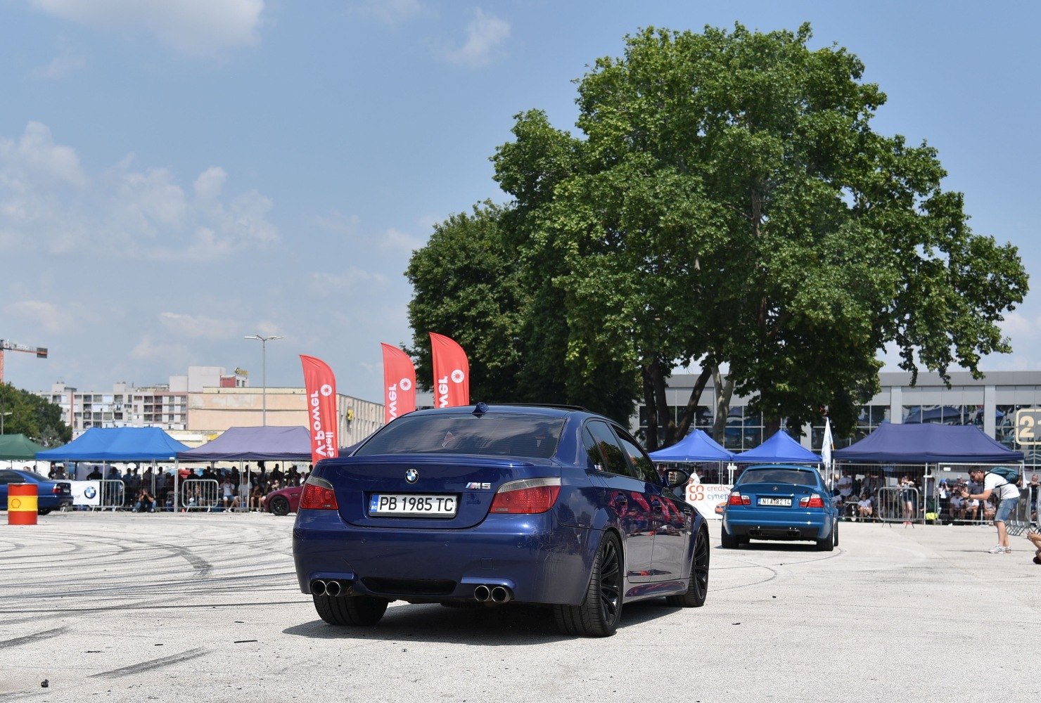 Rear view of sports sedan with quad exhausts and taillights