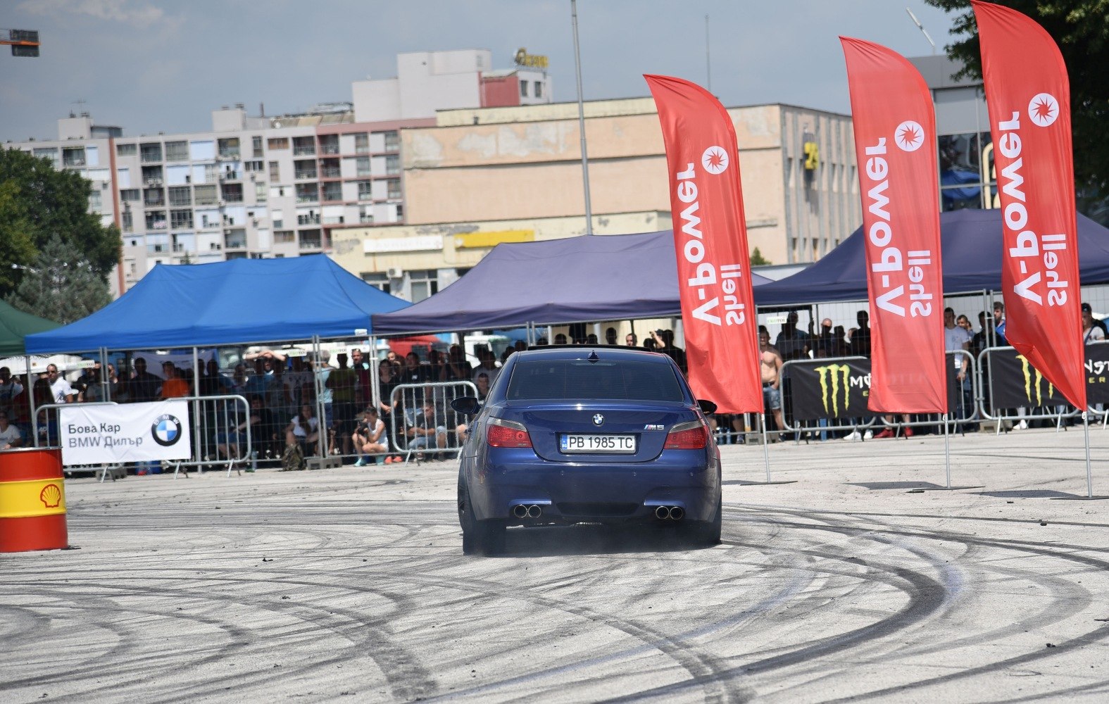Rear view of a performance sedan with burnout tire marks