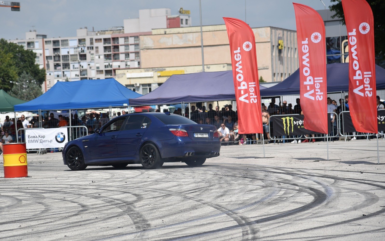 BMW M5 drifting with smoke, black rims, quad exhaust