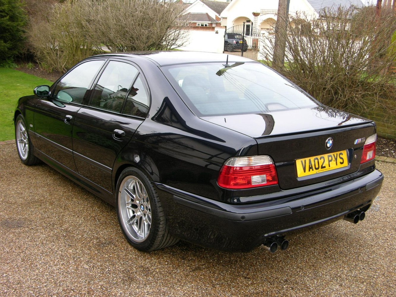 Rear and side view with quad exhaust and alloy wheels