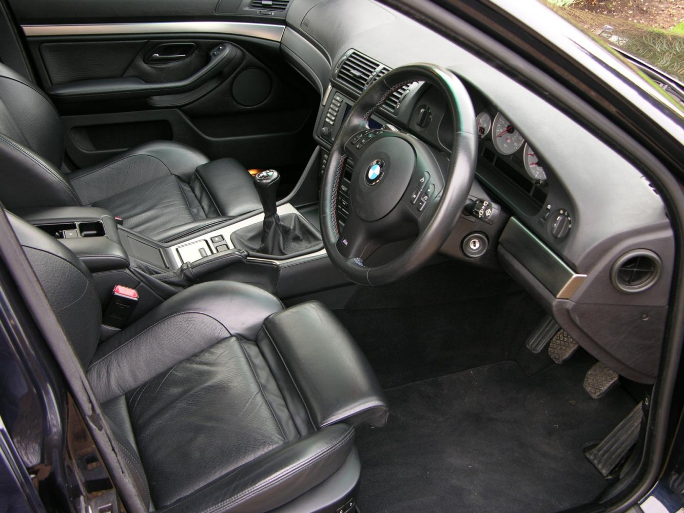 Black leather interior with manual transmission and classic BMW dashboard