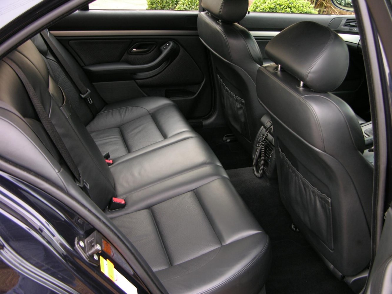 Black leather rear seats inside a premium sedan.