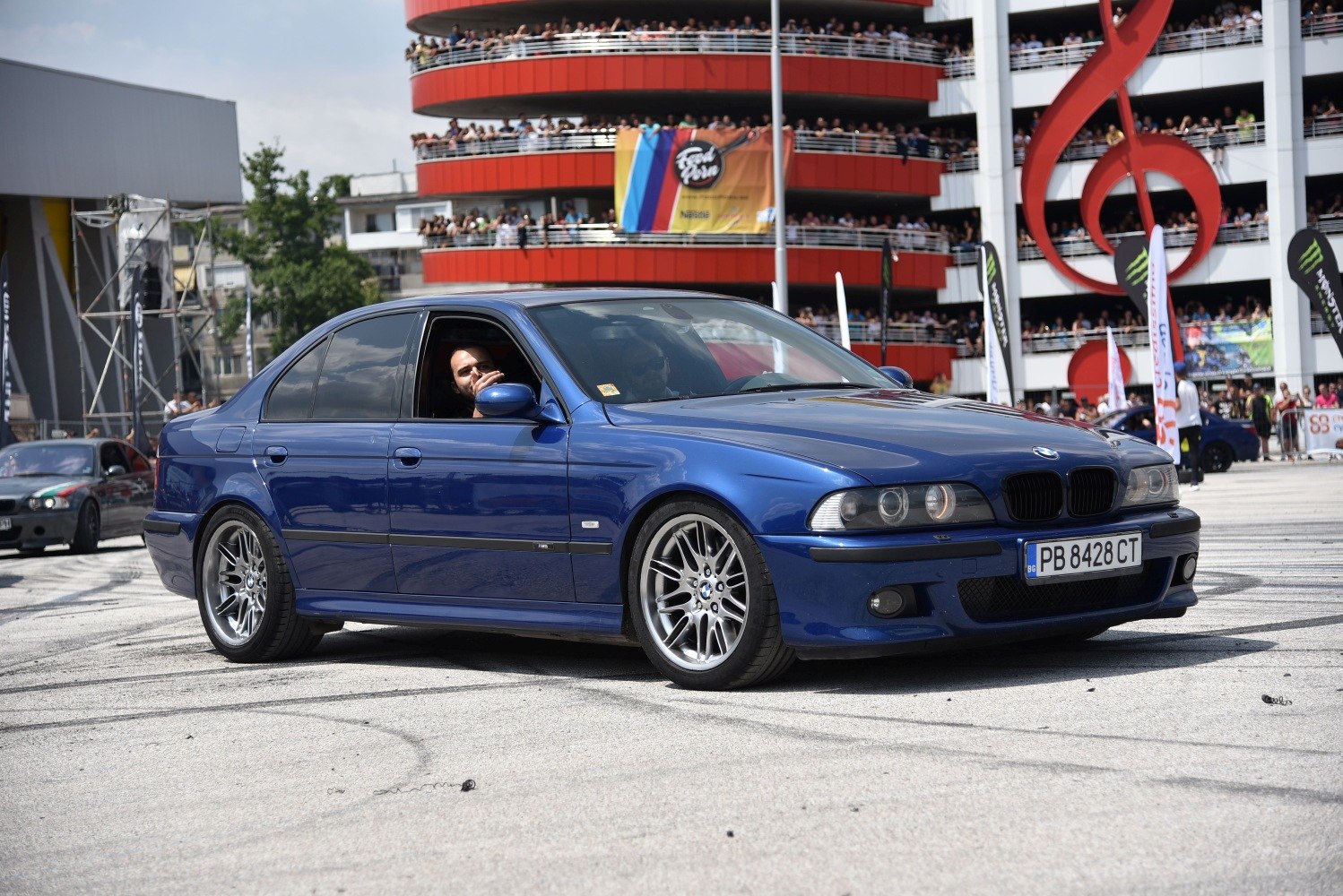 Blue luxury sedan with sporty alloy wheels and black grille