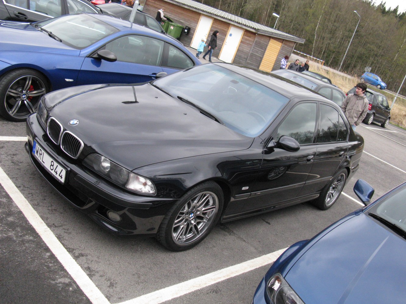 Black sedan with dual kidney grille and multi-spoke alloy wheels
