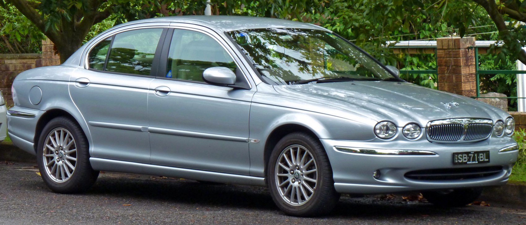 Silver sedan with round headlights and chrome grille